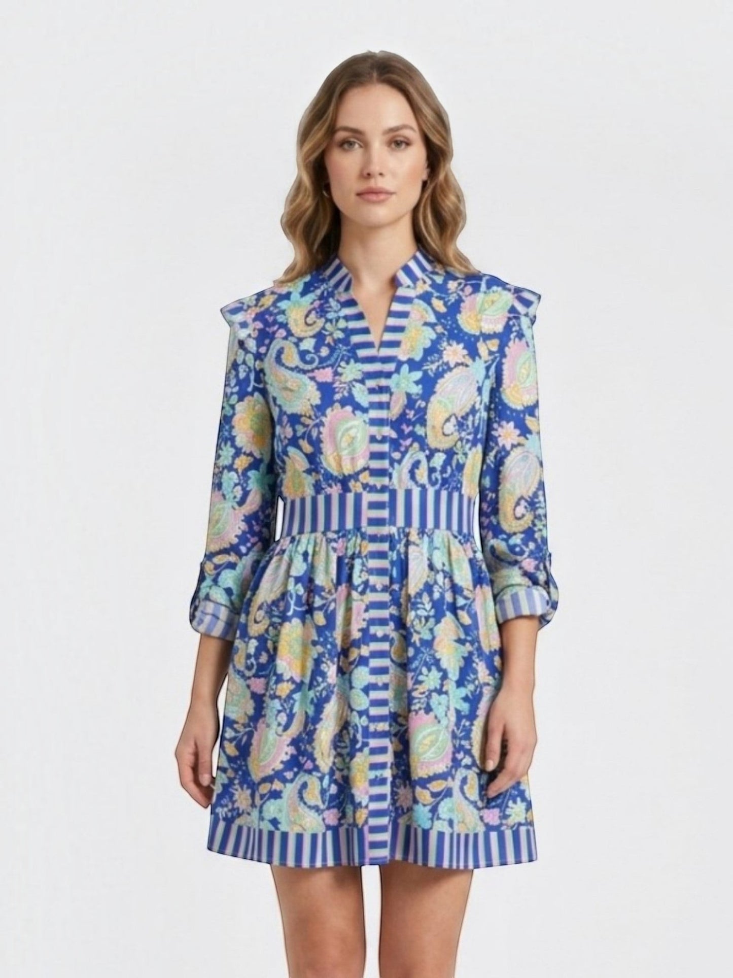 Catherine Martin blue paisley print mini dress with ruffled shoulders, button-front, and striped trim details.