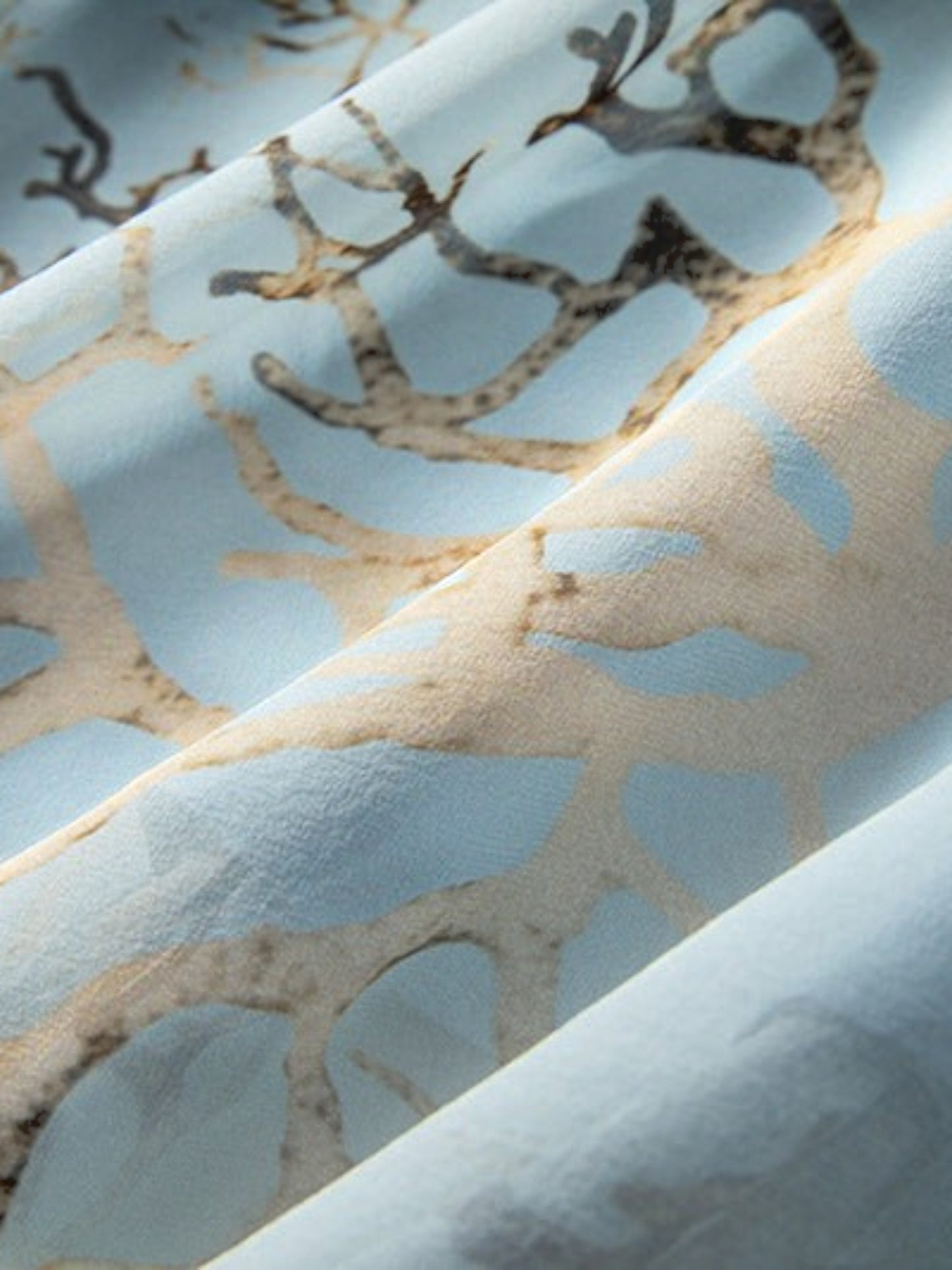 Catherine Martin powder blue mulberry silk fabric with a detailed gold and brown branch print pattern