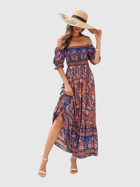 Catherine Martin boho maxi dress in blue floral rayon with puff sleeves, shirred bodice, and straw hat accessory