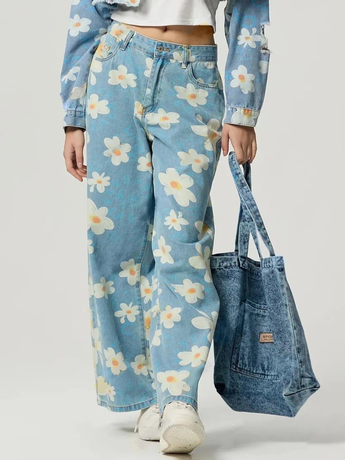 Catherine Martin wide-leg denim jeans featuring a playful cream and blue daisy print with a classic five-pocket design.