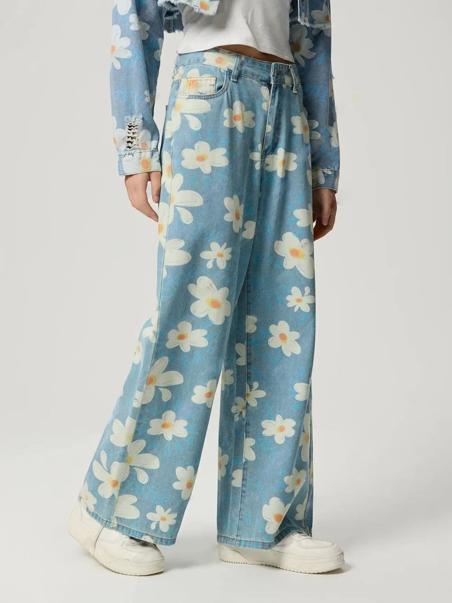 Catherine Martin wide-leg denim jeans featuring a playful cream and blue daisy print with a classic five-pocket design