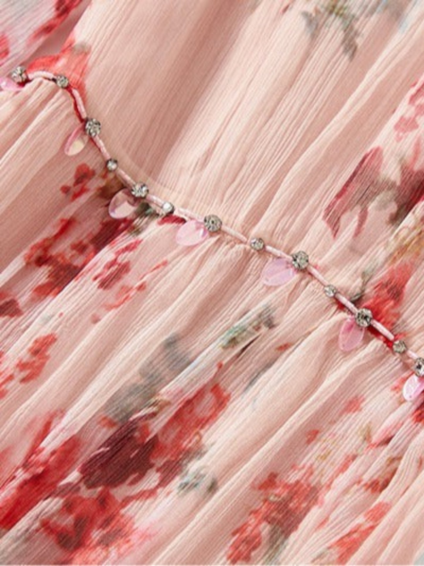 Catherine Martin floral silk dress detail featuring delicate crystal embellishments and pink petal accents.