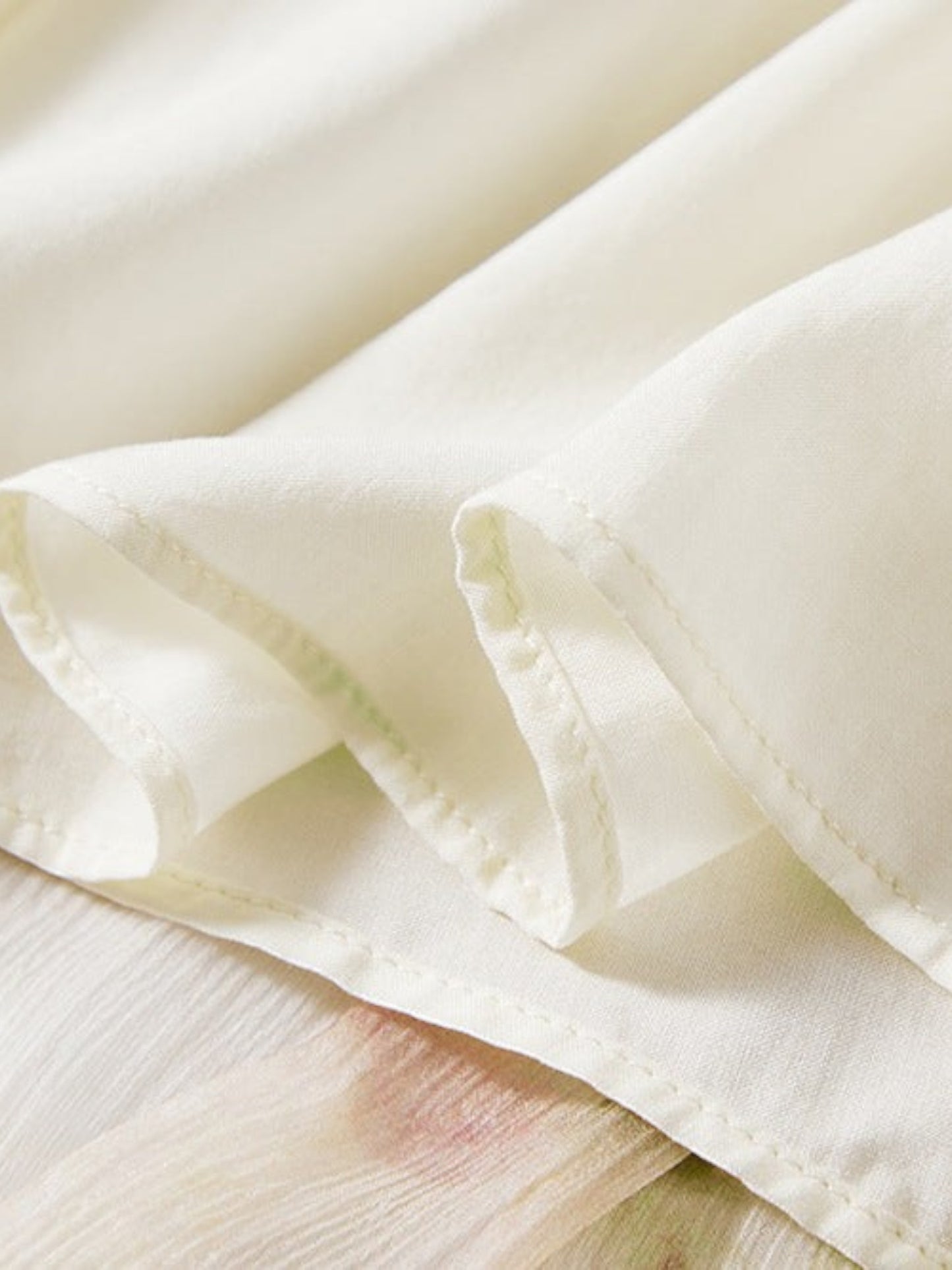 Catherine Martin floral silk midi dress fabric detail showing cream lining and delicate watercolour floral print