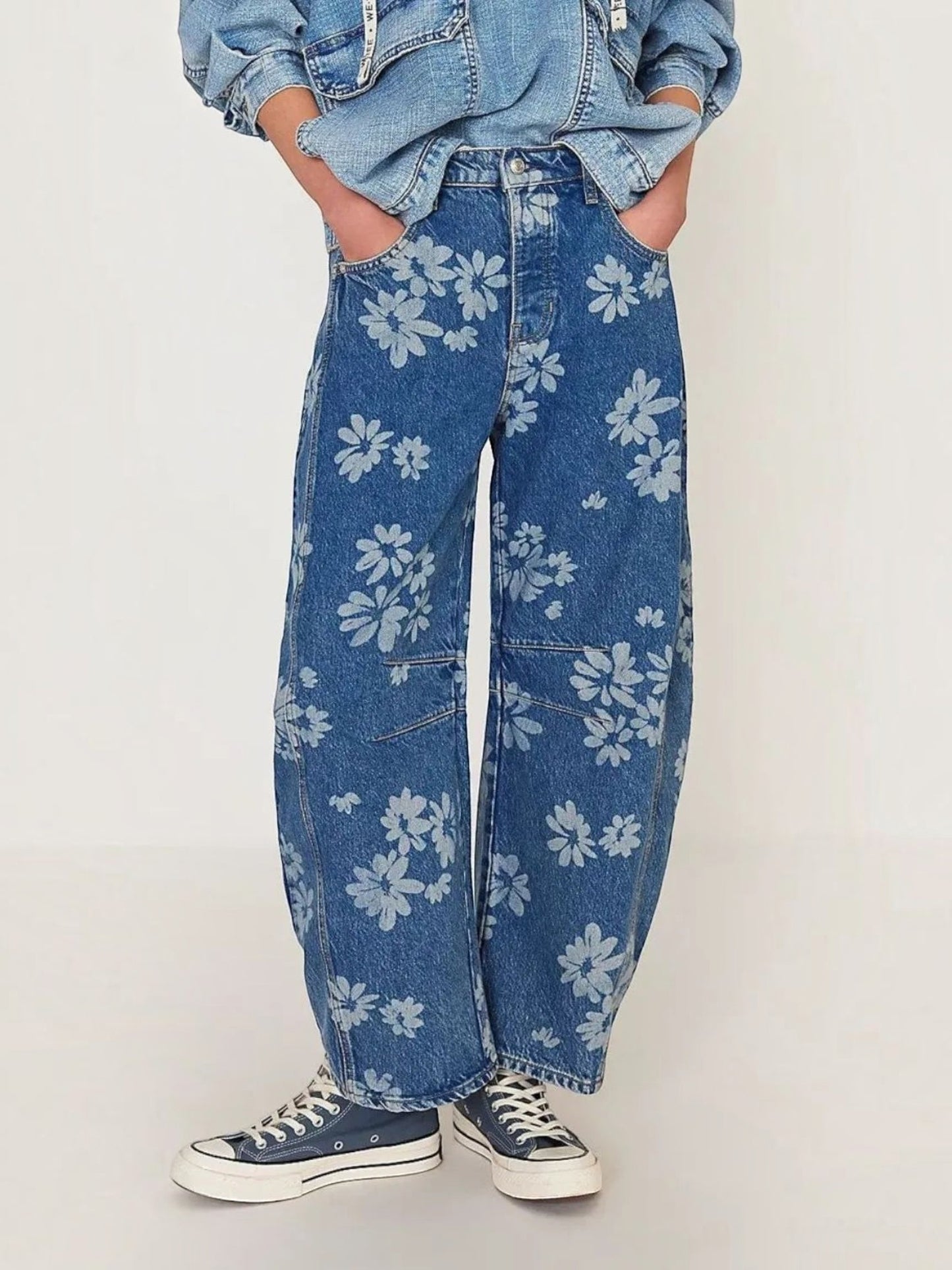 Catherine Martin wide-leg denim jeans featuring an all-over light blue floral print, front pockets, and relaxed fit.