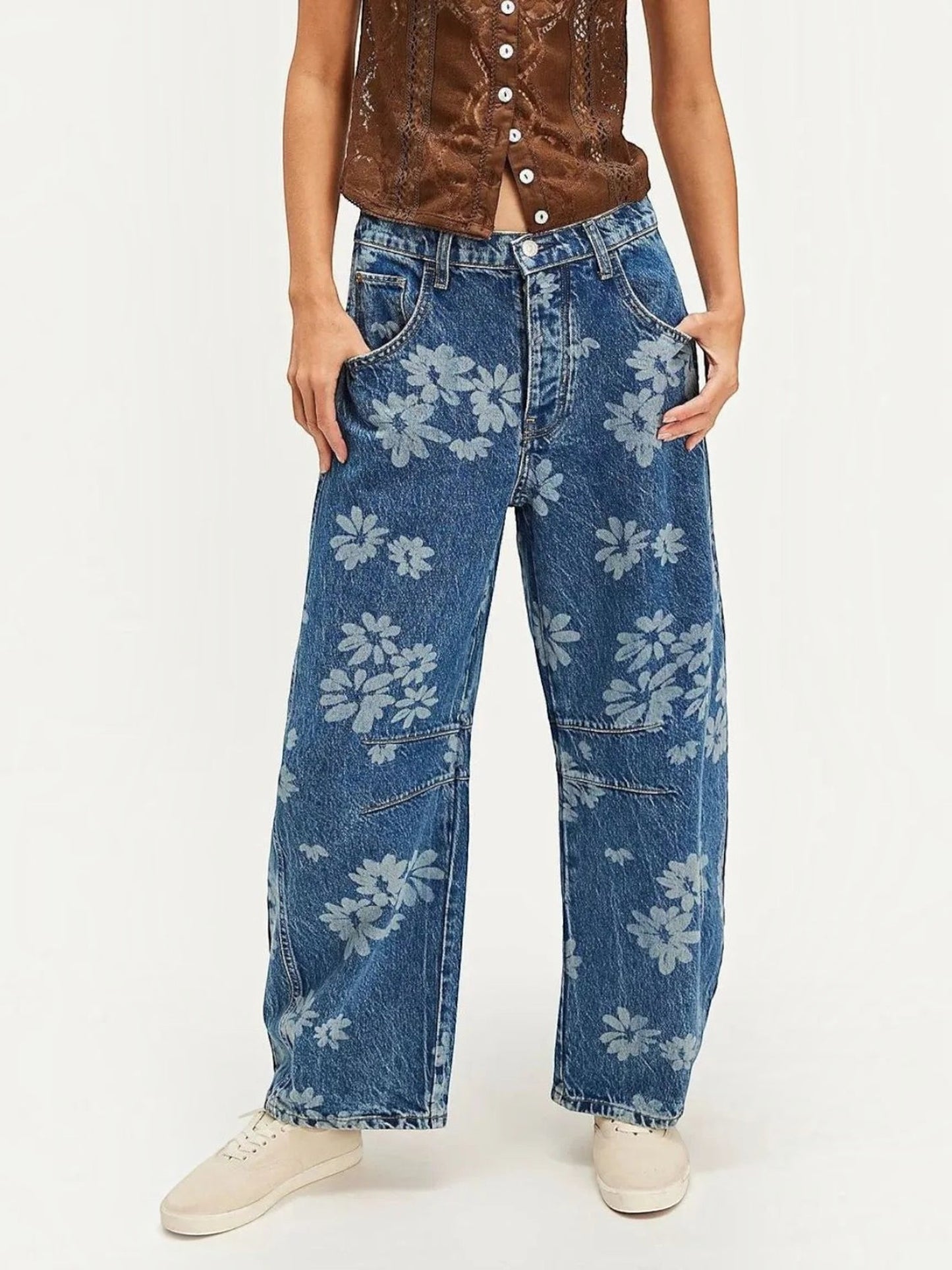 Catherine Martin wide-leg denim jeans featuring an all-over blue floral print, front pockets, and a relaxed fit.