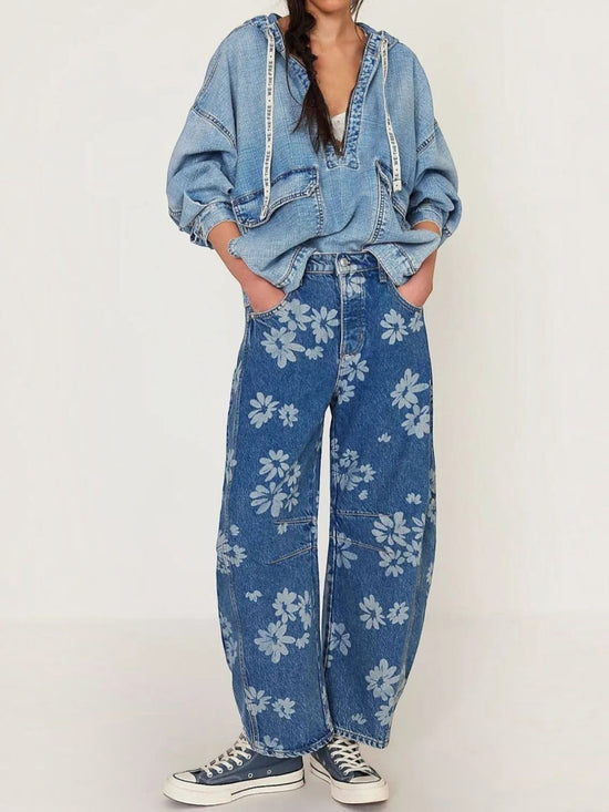 Catherine Martin wide-leg denim jeans featuring a light blue floral print, worn with a matching denim hoodie.