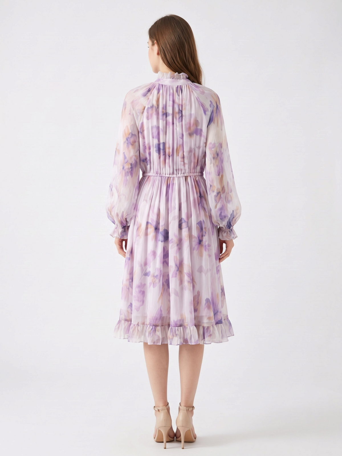 Back view of a Catherine Martin lilac floral silk chiffon dress with ruffled collar, long sleeves, and ruffle hem.