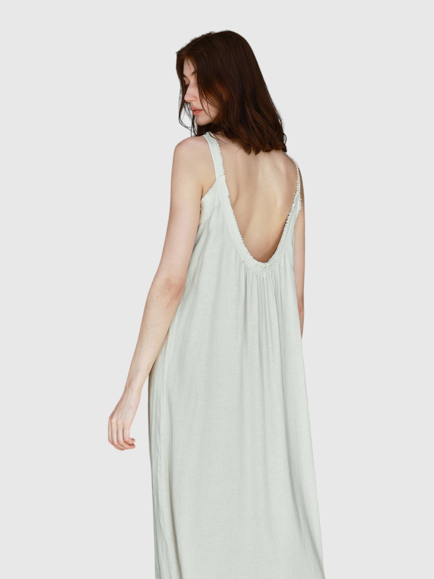 Catherine Martin linen and cotton maxi dress in light sage with a low open back and frayed raw edge detailing.