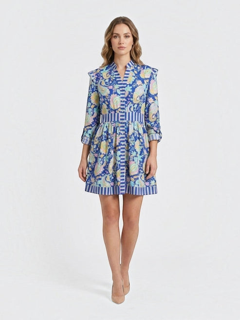 Catherine Martin paisley print mini dress in blue polyester with ruffled shoulders, button front, and striped trim.