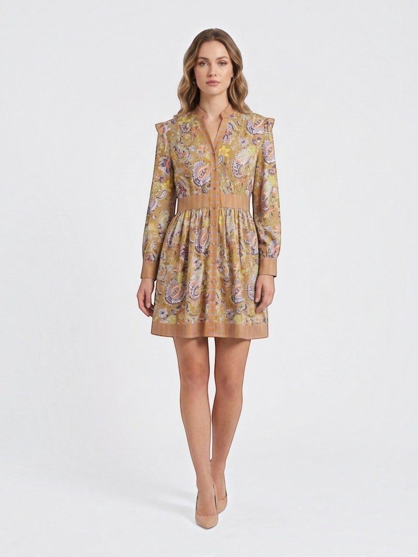 Model wearing a Catherine Martin paisley print mini dress with ruffled shoulders, long sleeves, and striped trim.