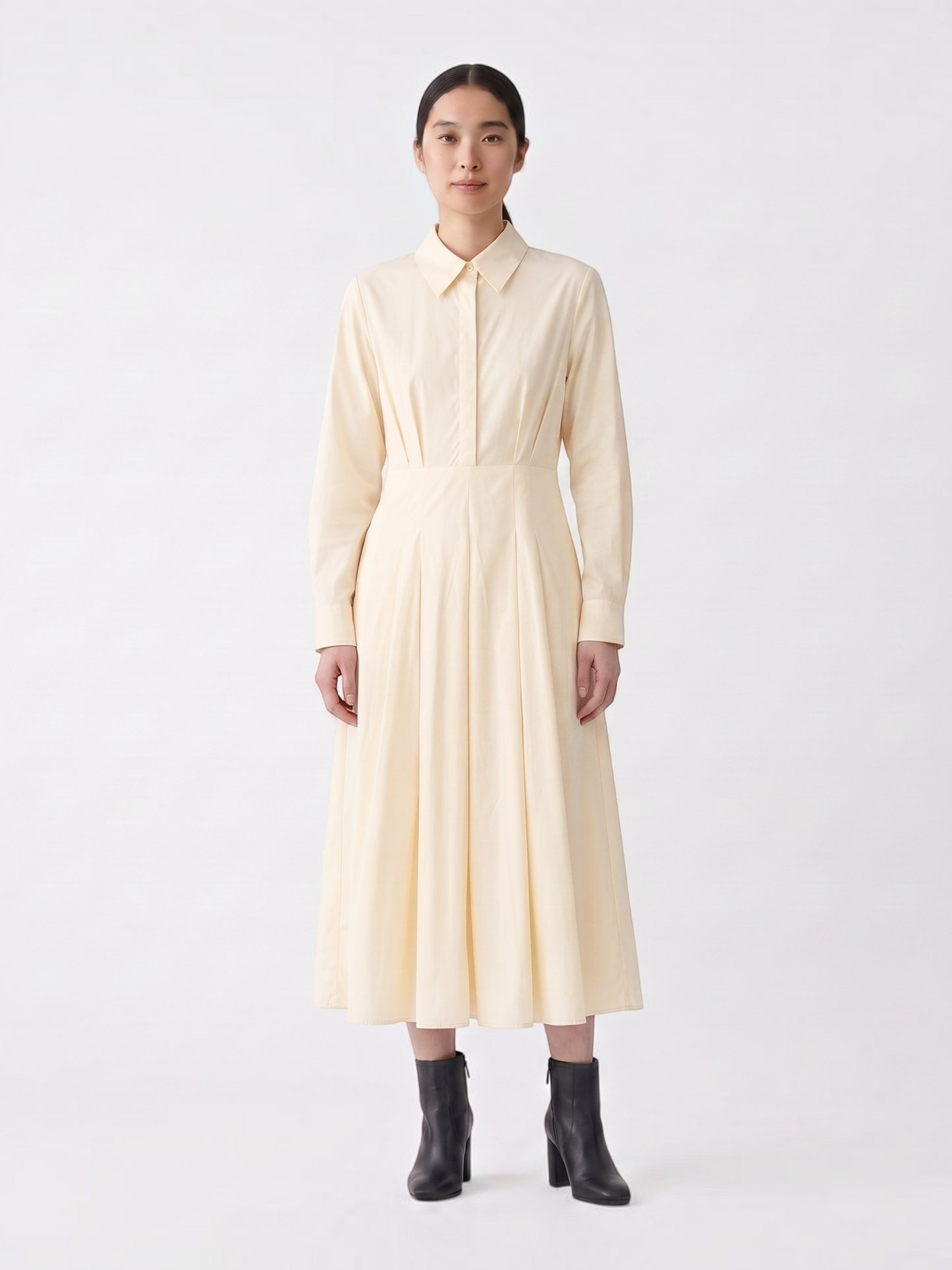 Catherine Martin pale yellow cotton midi shirt dress with a pointed collar, pleated skirt, and long sleeves.