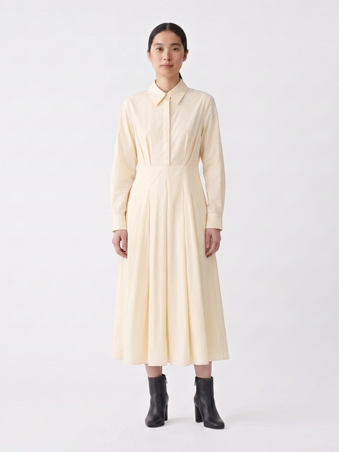 Catherine Martin pale yellow cotton midi shirt dress with a pointed collar, pleated skirt, and long sleeves.