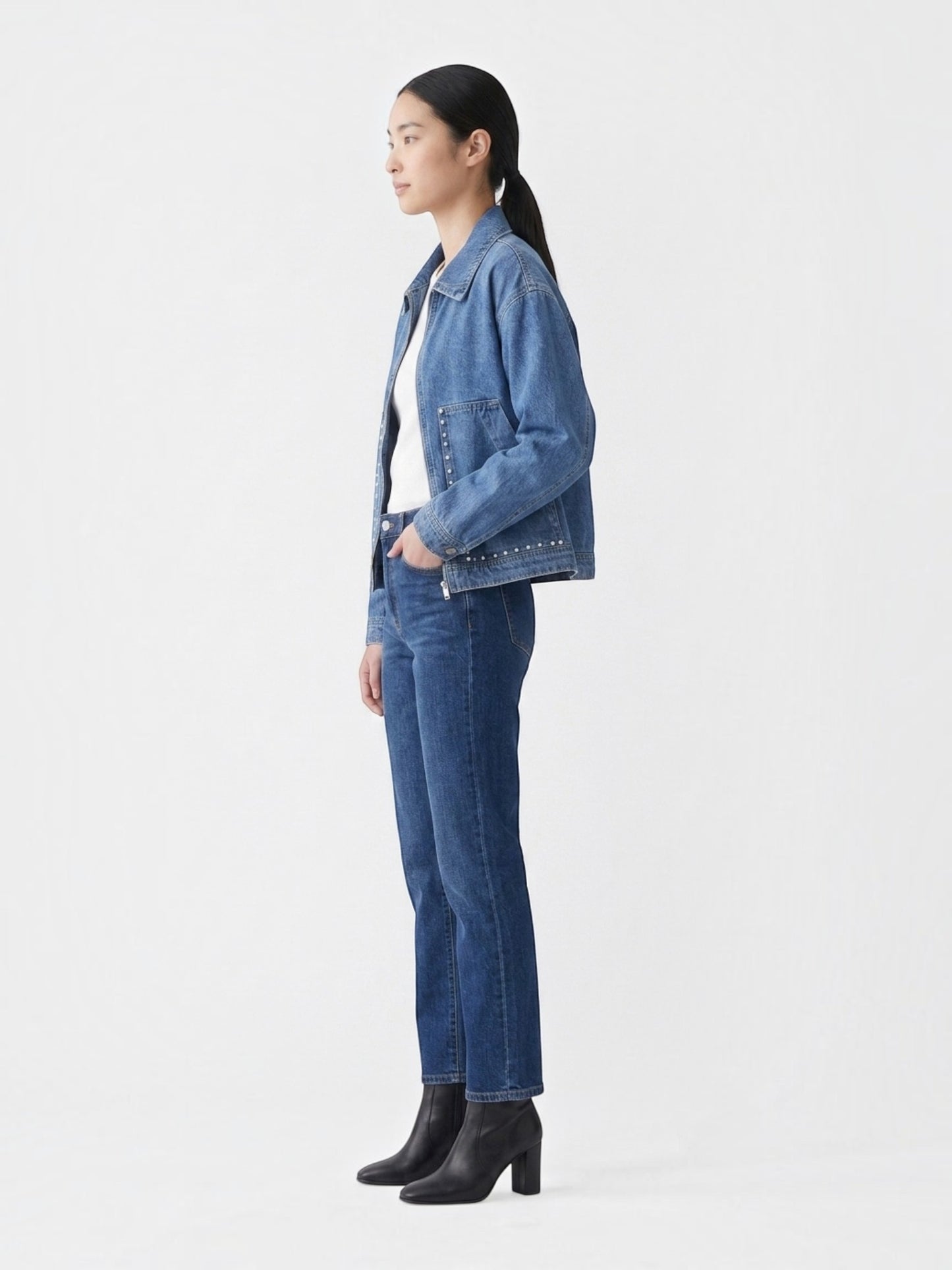 Catherine Martin light-wash denim jacket with pearl stud details, metal zipper, and relaxed fit on a female model.