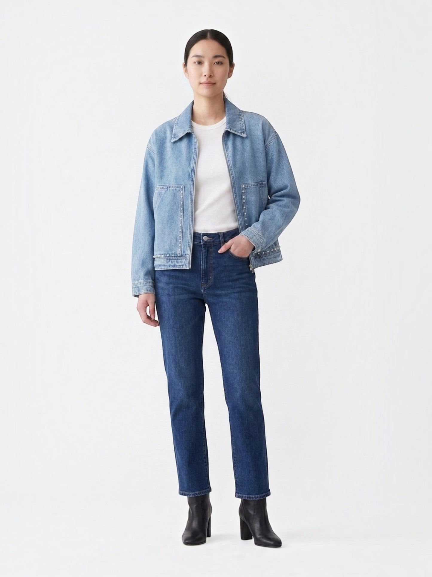 Catherine Martin light-wash denim jacket with pearl stud details, front zipper, and collar worn by a model.