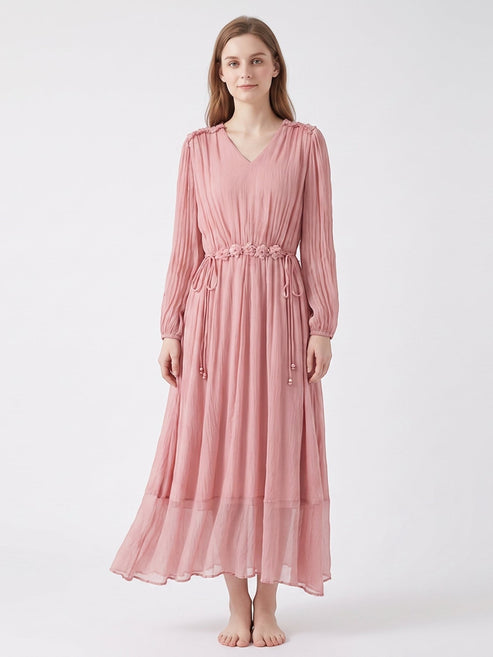 Catherine Martin pink silk midi dress with V-neck, long sleeves, and floral waist tie detail on a model.