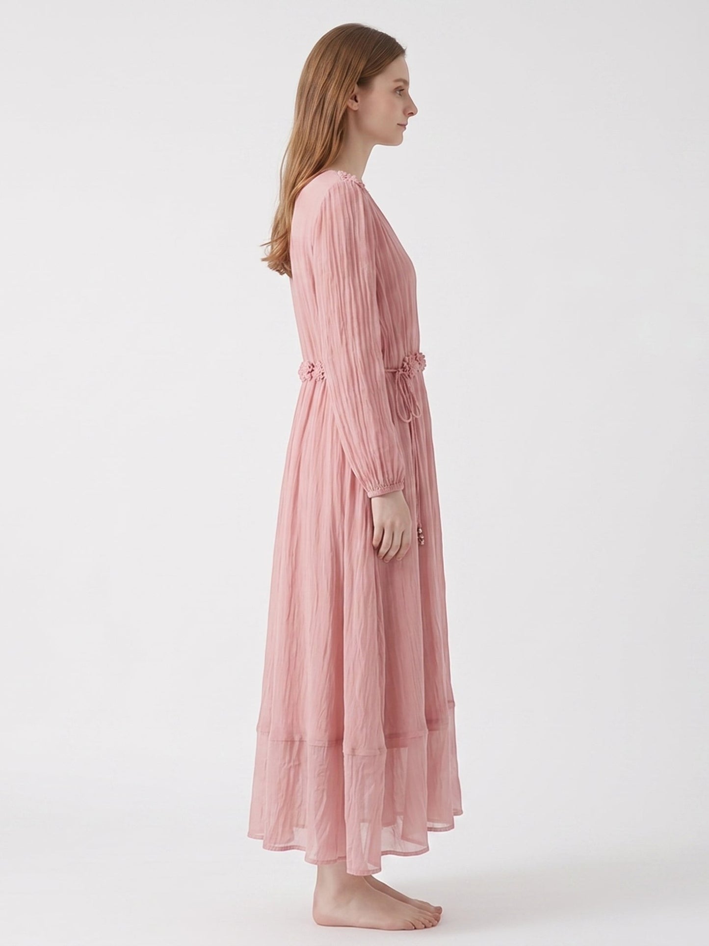 Catherine Martin soft pink silk midi dress with floral waist trim, V-neckline, and long sleeves on a model