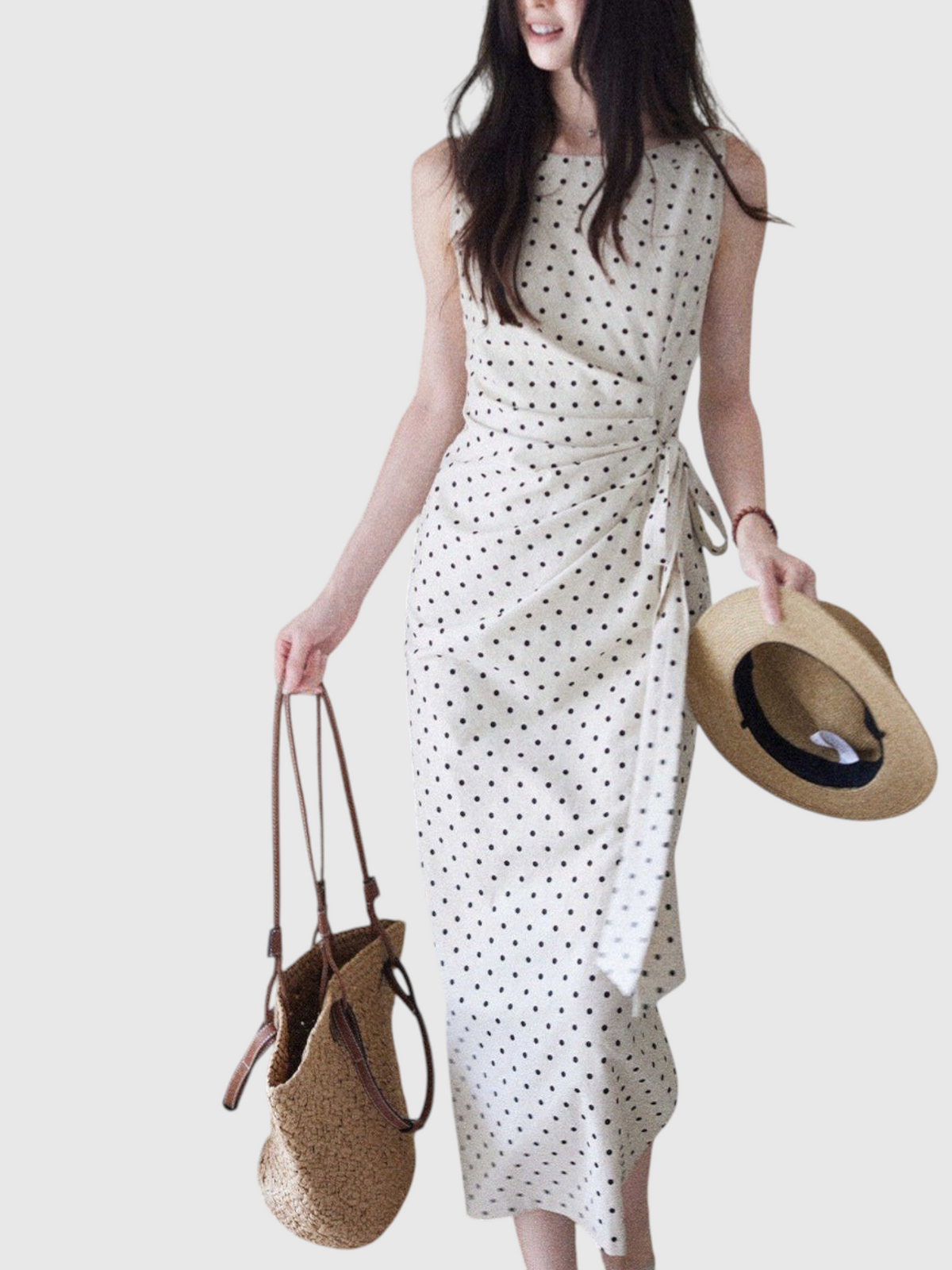 Catherine Martin polka dot midi dress in linen-cotton blend with boat neckline, side tie, and draped waist detail.