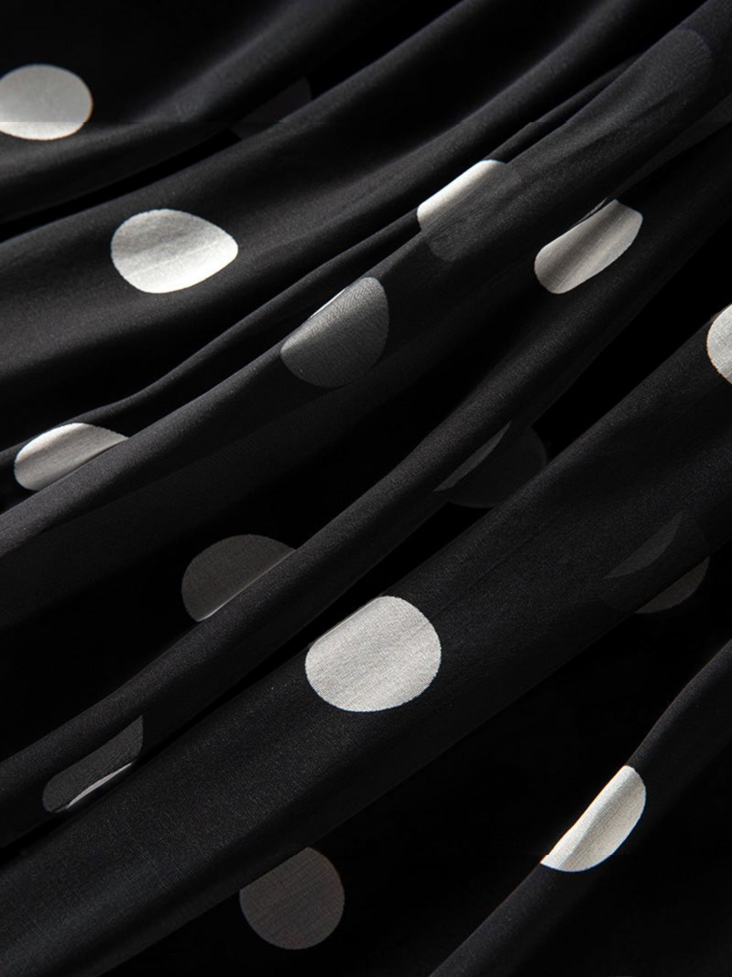 Catherine Martin black and white polka dot silk fabric with soft folds and elegant drape