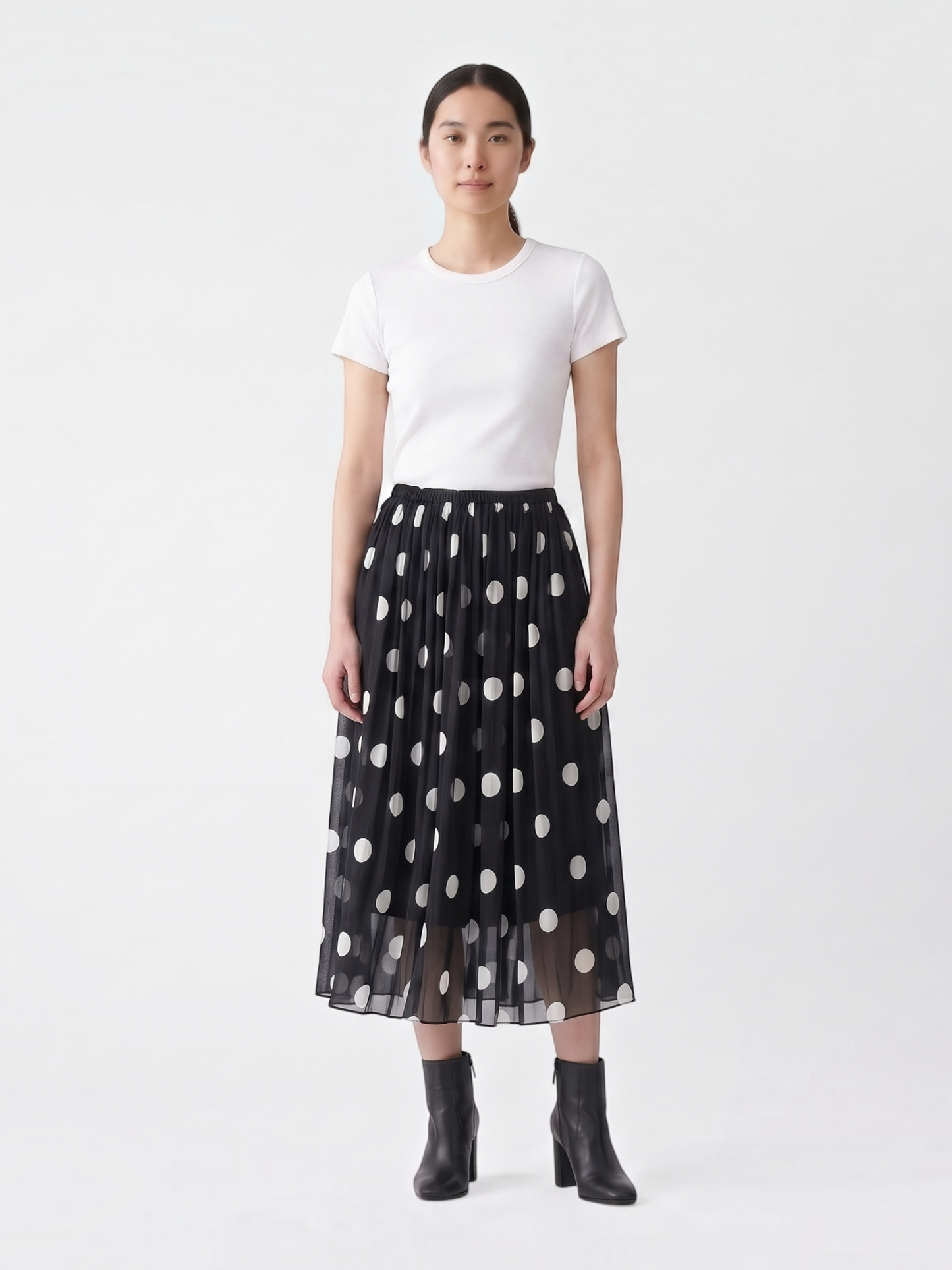 Catherine Martin black and white polka dot silk midi skirt with an A-line silhouette and elastic waistband on a model