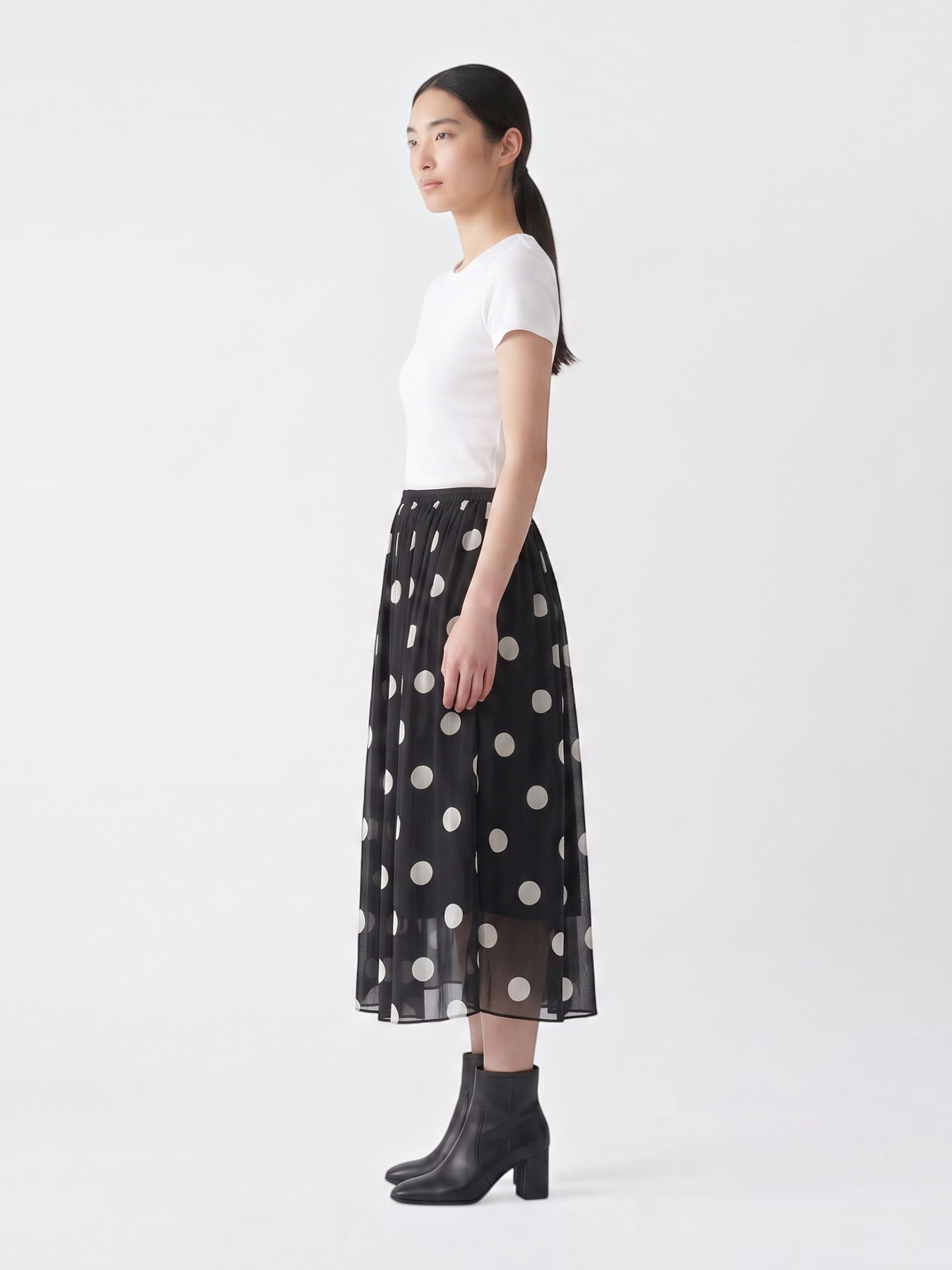 Catherine Martin black and white polka dot silk midi skirt with an A-line silhouette and elastic waistband on a model