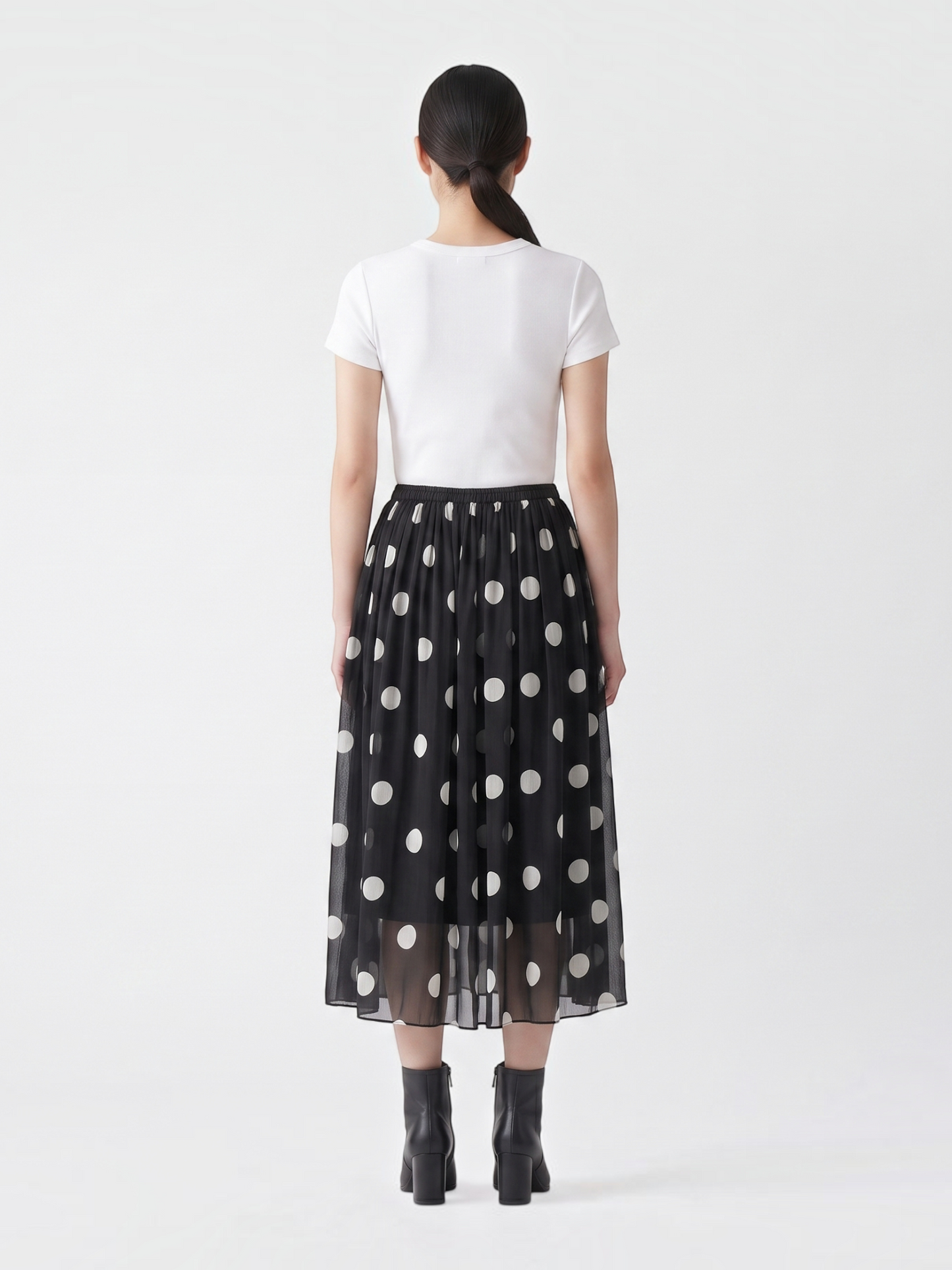 Catherine Martin black and white polka dot silk midi skirt with elastic waistband, back view on a model