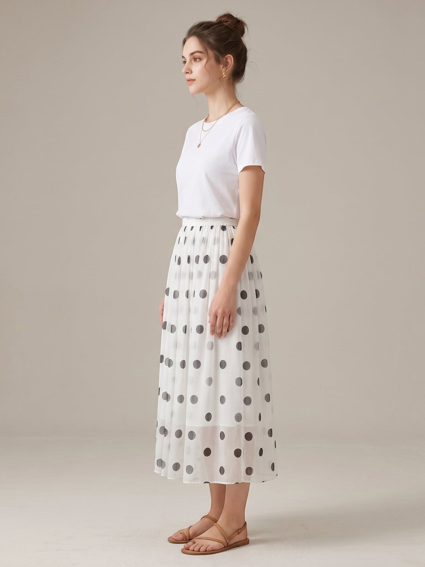 Catherine Martin white silk midi skirt with black polka dots, A-line silhouette, and elastic waist on a model