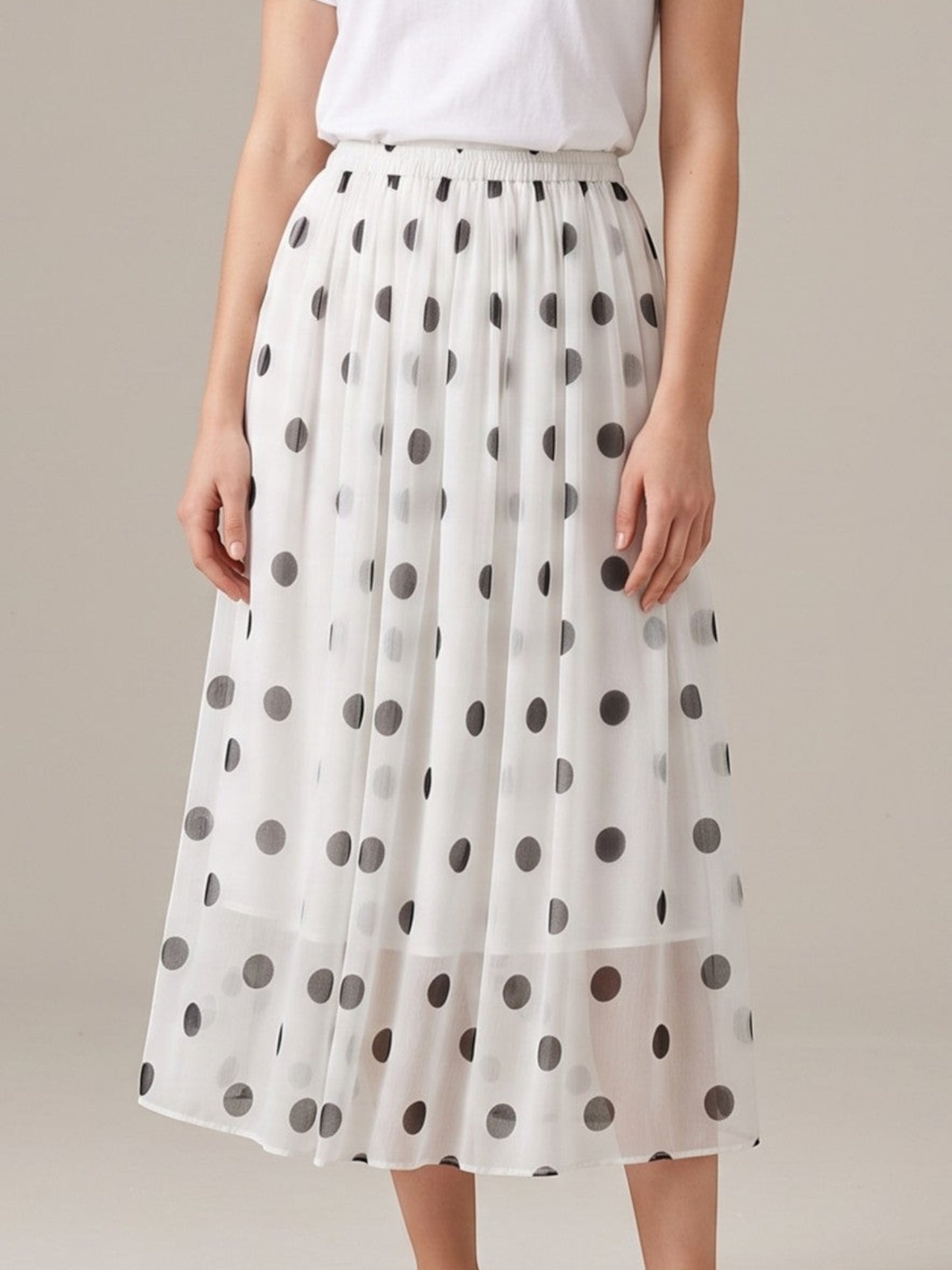 Catherine Martin white silk midi skirt with black polka dots, A-line silhouette, and elastic waistband.