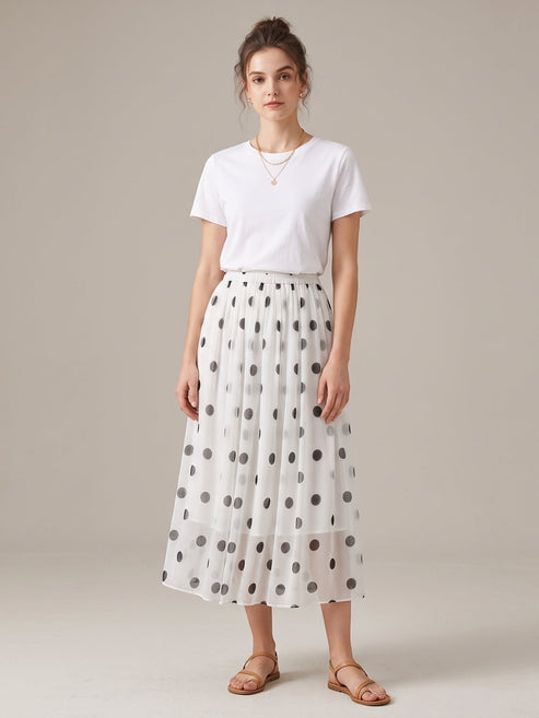 Catherine Martin white silk midi skirt with black polka dots, A-line silhouette, and elastic waist on a model.