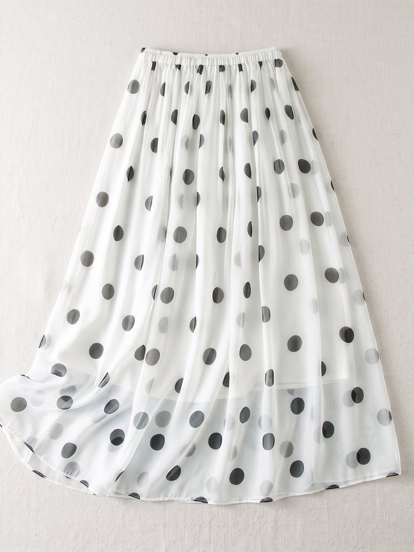 Catherine Martin white silk midi skirt with black polka dot print, A-line silhouette, and elastic waistband.