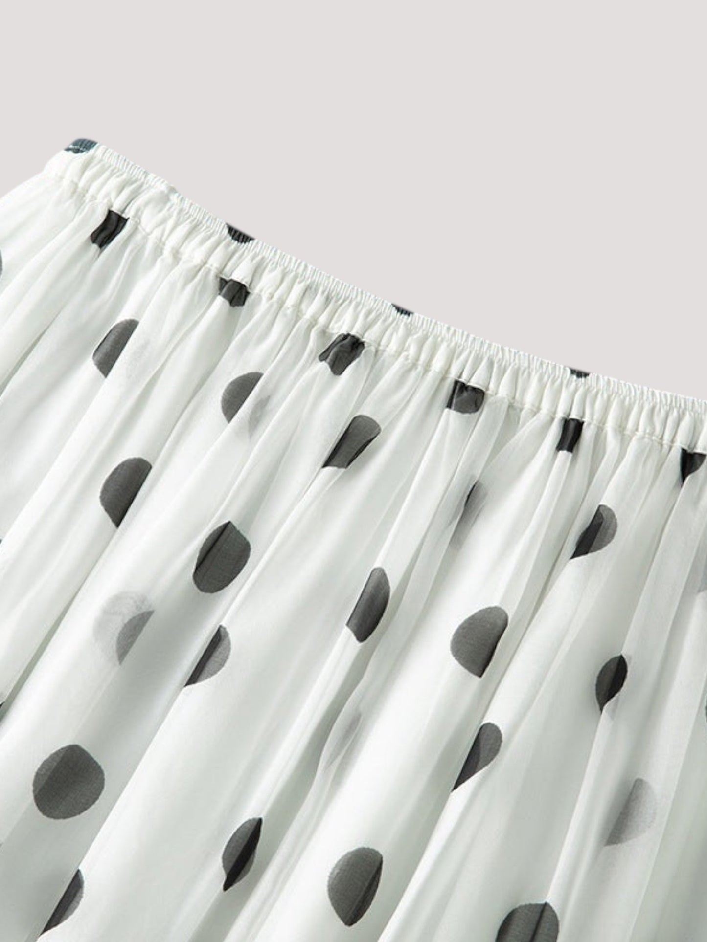 Catherine Martin white silk midi skirt with black polka dot print, featuring fine pleating and an elastic waistband.