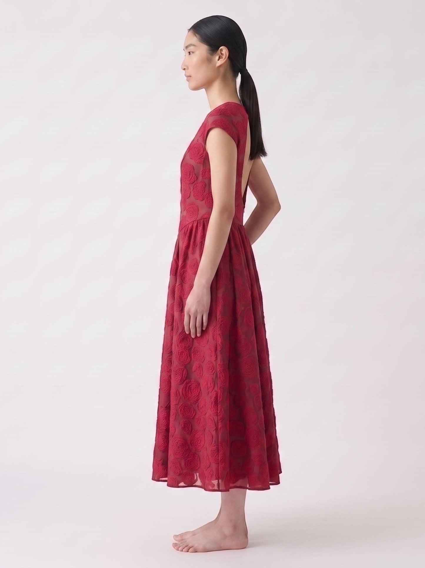 Catherine Martin red rose jacquard mid-length backless dress with short sleeves on a model, side view
