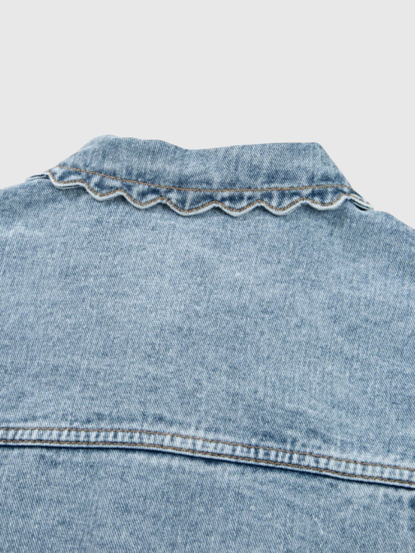 Catherine Martin light wash denim jacket collar with delicate scalloped trim detail