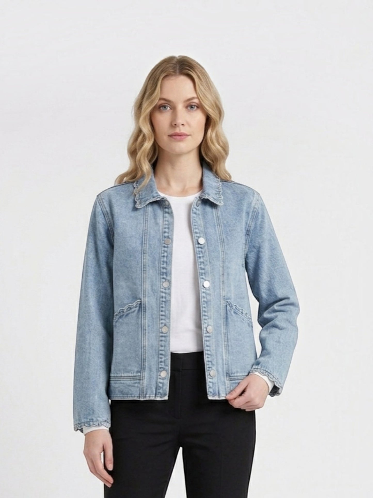 Catherine Martin light wash denim jacket featuring a collared neckline and delicate scalloped trim on a model.