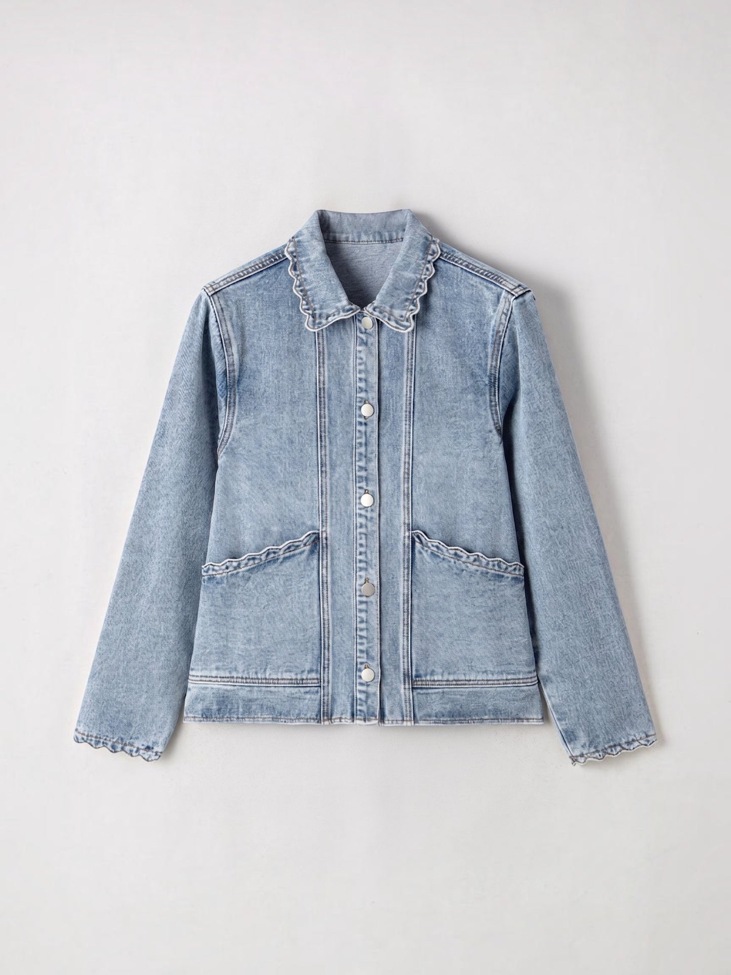 Catherine Martin light-wash denim jacket with a collared neckline, pearl-style snap buttons, and scalloped trim.