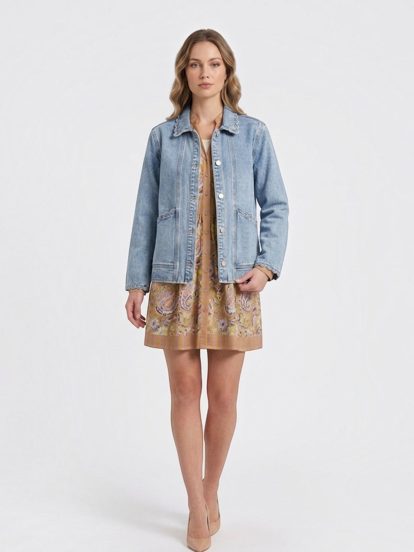 Catherine Martin light-wash denim jacket with scalloped trim, collar, and pearl-style snap buttons on a model.