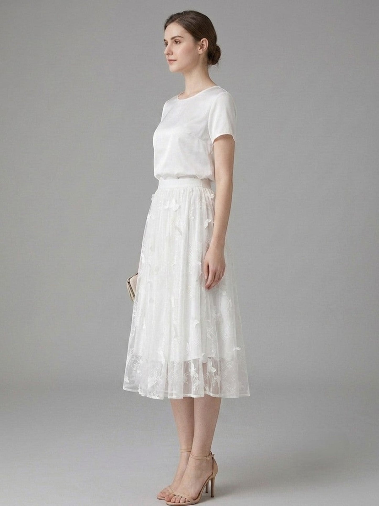 Catherine Martin white silk midi skirt with butterfly and floral embroidery in an A-line silhouette on a model