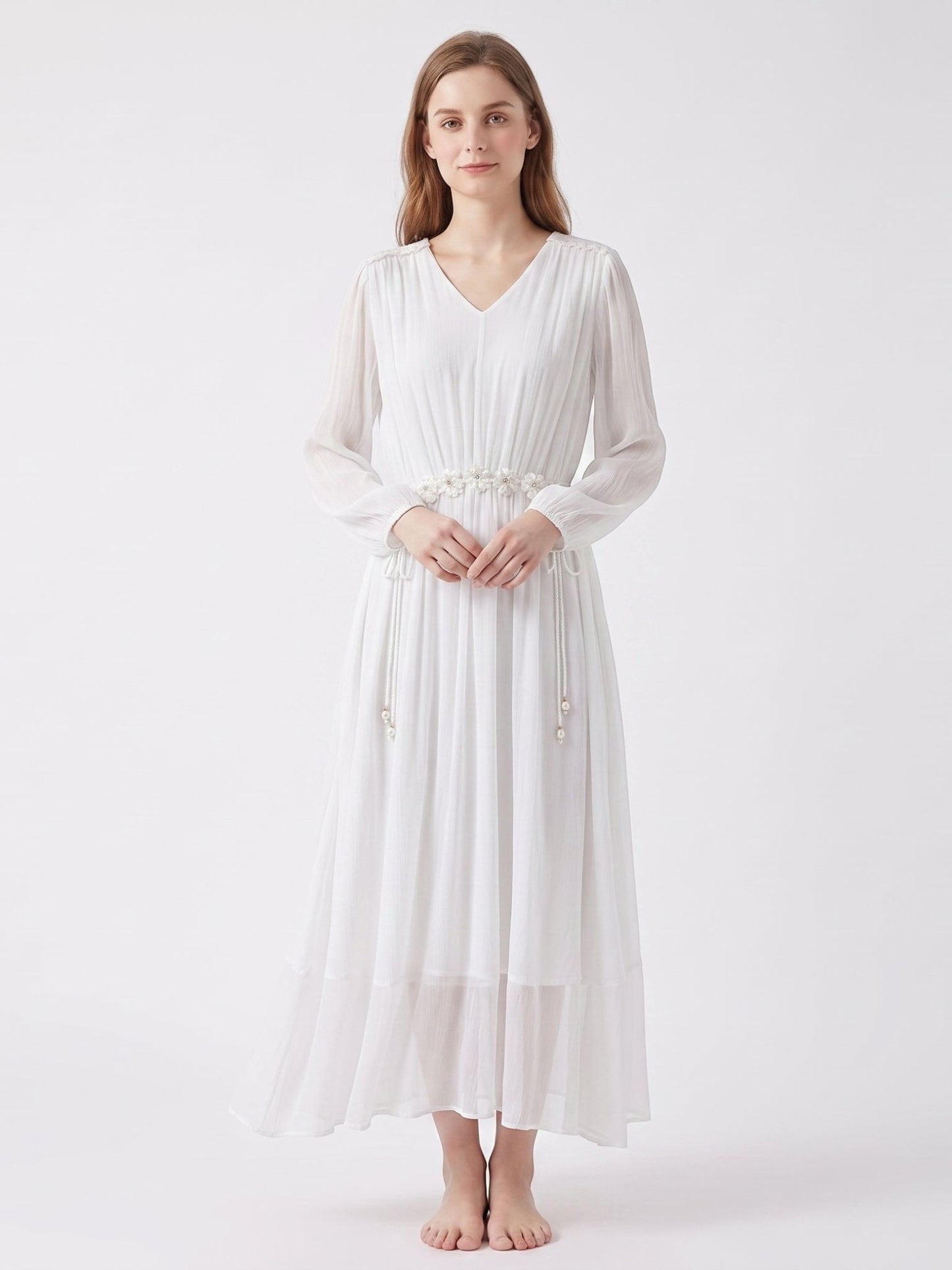Catherine Martin white silk midi dress with V-neck, long sleeves, and floral waist tie detail on a female model