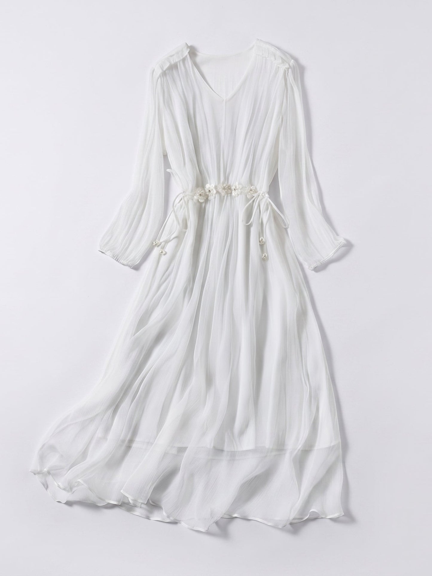 Catherine Martin white silk midi dress with V-neck, long billowy sleeves, and floral waist tie detail.