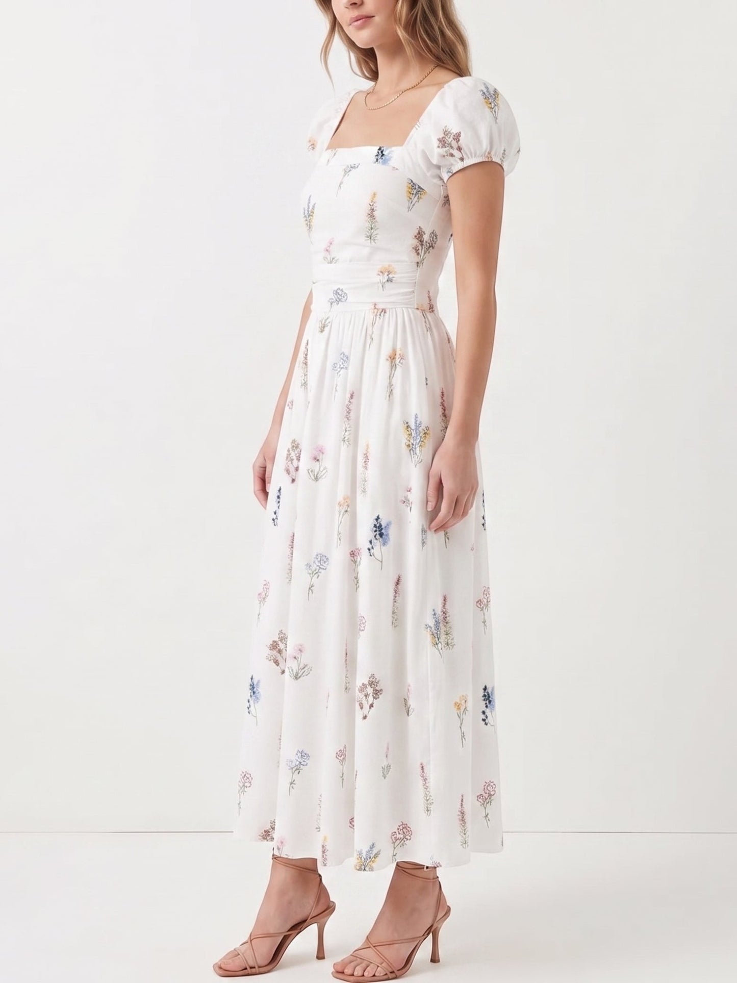 Catherine Martin white cotton midi dress with wildflower print, square neckline, puff sleeves, and smocked bodice.