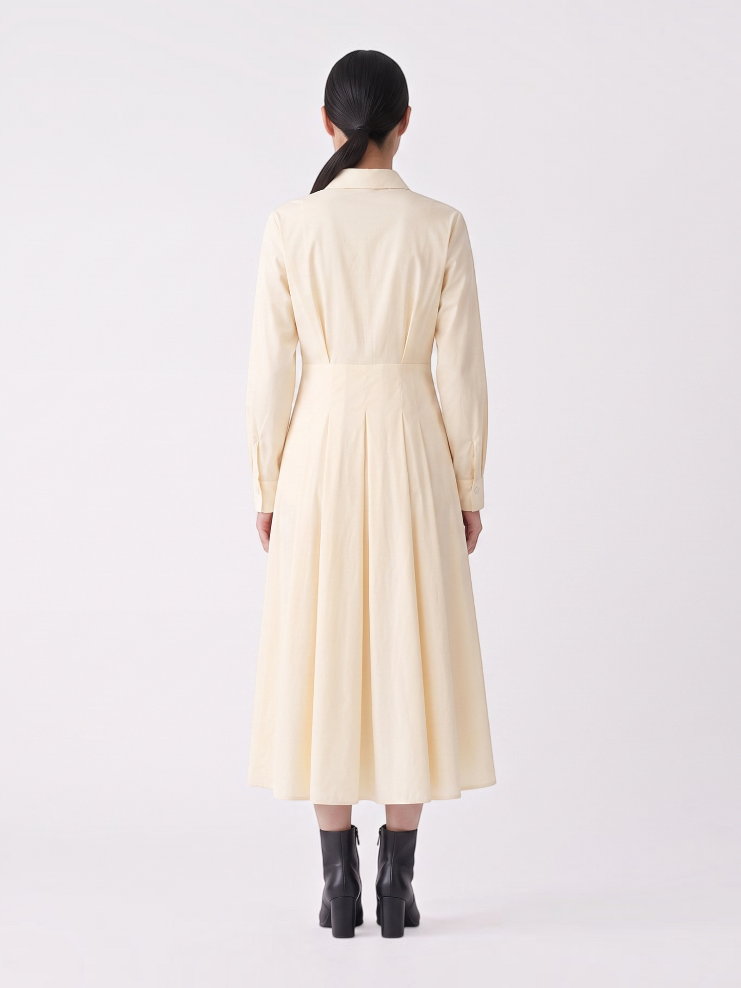Catherine Martin pale yellow cotton midi shirt dress with a pleated skirt and long sleeves, back view
