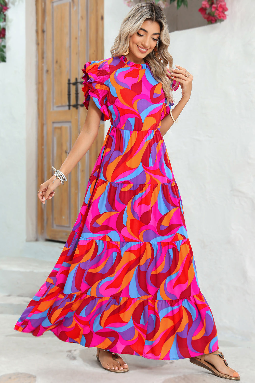 Front view of model wearing tiered maxi dress with short sleeves and ruffle details.