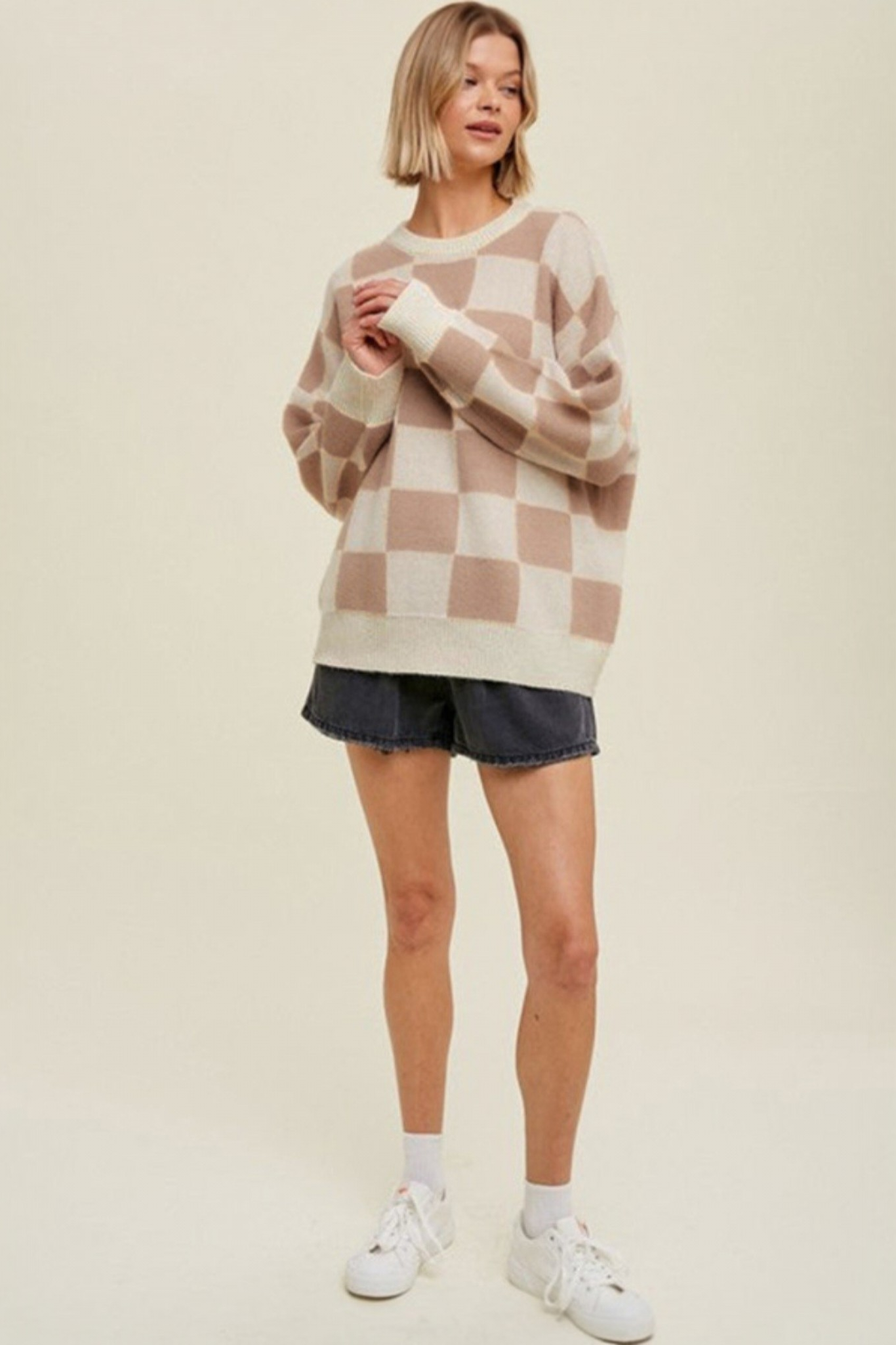 Mocha checkerboard crew neck knit sweater front full length view styled with black denim shorts and white sneakers