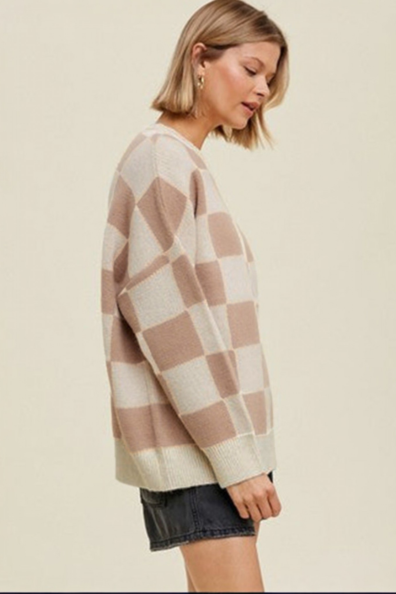 Mocha checkerboard crew neck knit sweater side view showing oversized relaxed fit and ribbed hem detail