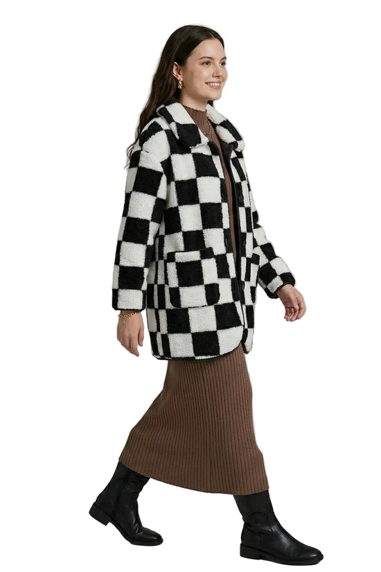 Side profile of the plush checkerboard coat, highlighting the relaxed fit and soft, textured teddy fleece material.