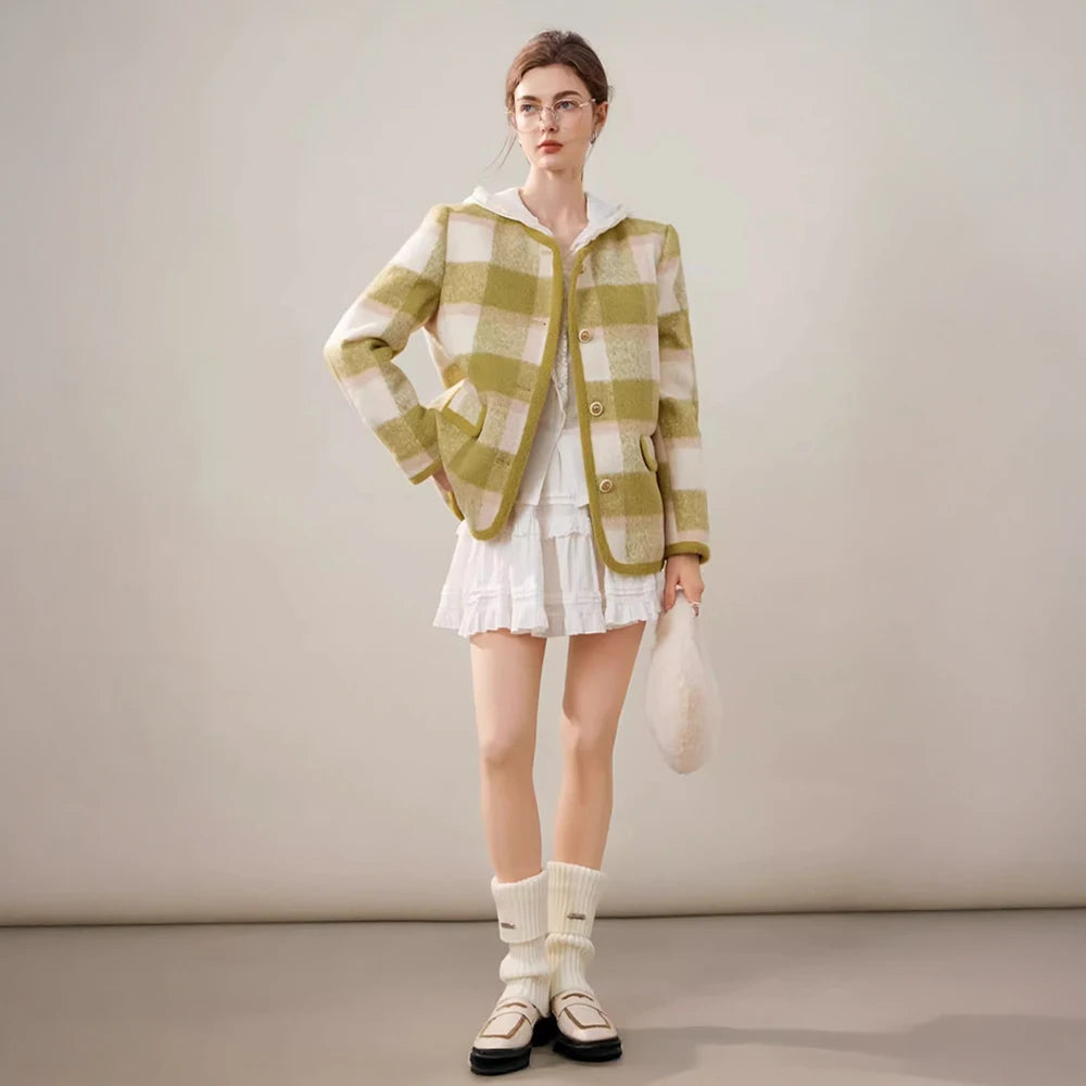 Woman wearing a green and white checkered outfit with a white background