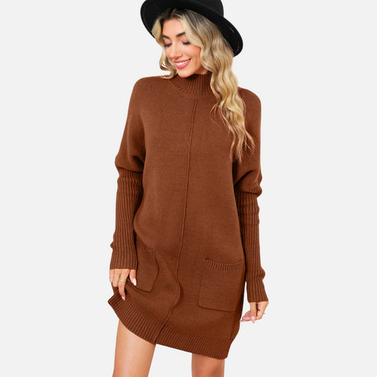 Front view of a model wearing a chestnut brown high-neck knit mini dress with functional front pockets and a vertical centre seam detail.