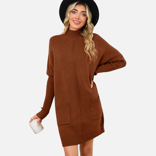 Front view of a model wearing a chestnut brown high-neck knit mini dress with functional front pockets and a vertical centre seam detail.