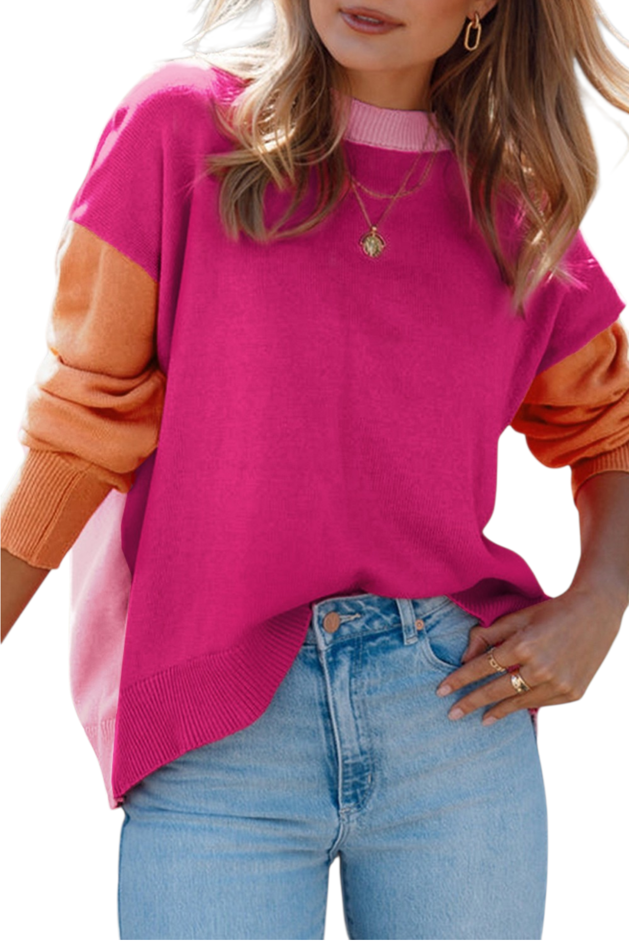 A close-up shot of the oversized magenta sweater, showing the ribbed texture of the cuffs and the light pink collar. The model has her hand tucked into her denim pocket, emphasizing the relaxed, slouchy fit of the knit.