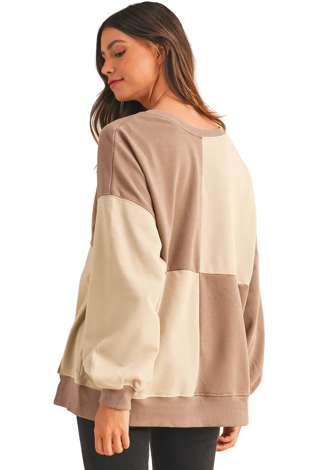 Three-quarter rear view of the taupe patchwork sweatshirt highlighting the slouchy drop-shoulder sleeves.