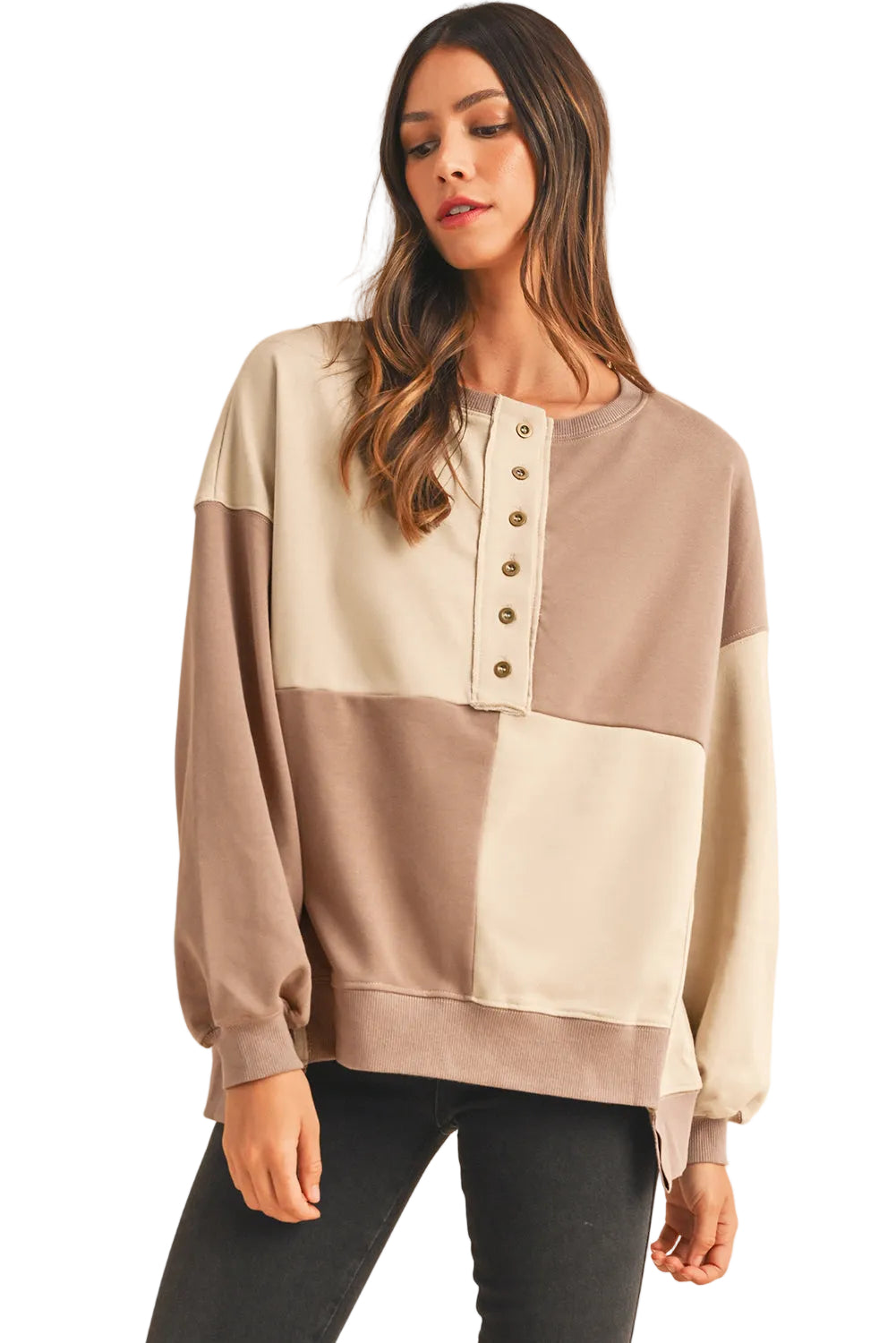 Model styling the cream and taupe neutral version of the patch button sweater, showing the relaxed neck line.